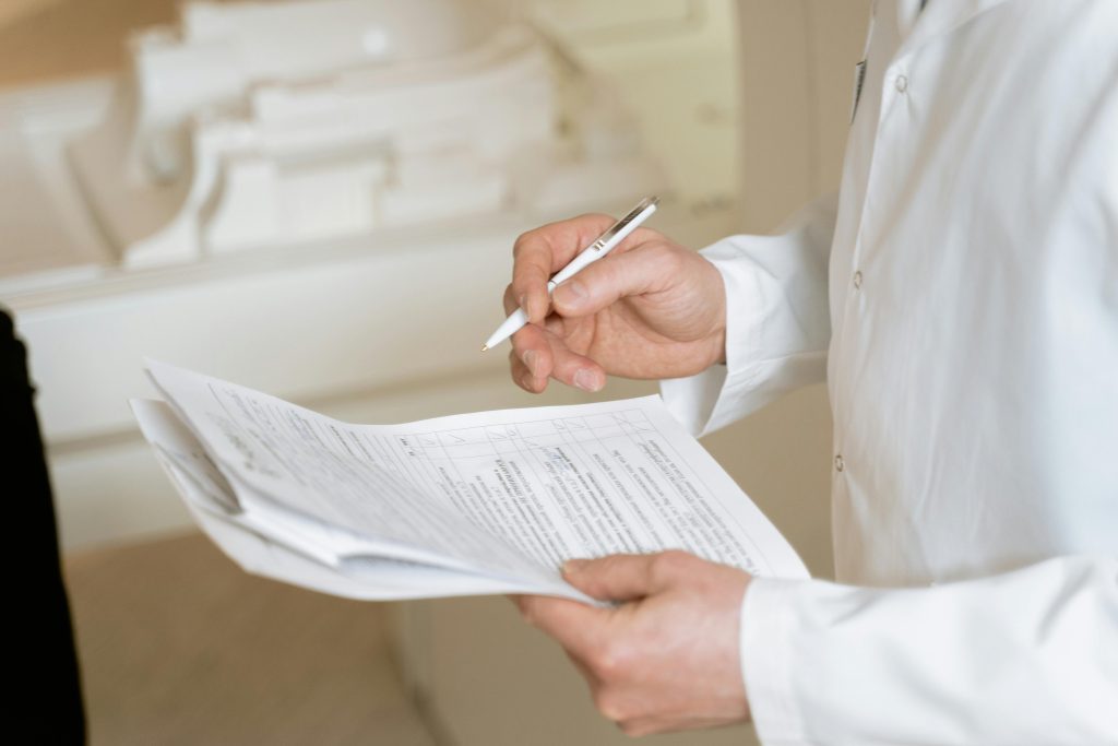 pexels-photo-7089620-7089620-1 A doctor holds and reviews medical documents, demonstrating careful examination and professionalism.